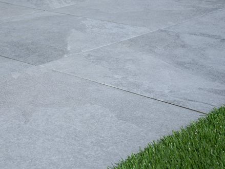 Płyty tarasowe Alpine Grey o jasnym wyglądzie łupka z obrzeżem do trawnika